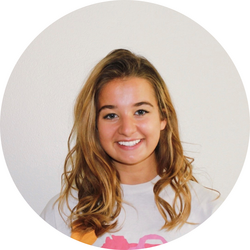 Close-up headshot of tutor Summer wearing a white hoodie and standing in front of a white background.